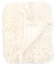 the white blanket is folded on top of it's fluffy, shaggy edges and has a triangle at the bottom