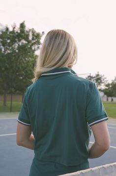 Our Courtside Green Tennis Polo Shirt is perfect for an athletic look. Constructed from butter-soft fabric, this crop-length shirt features a classic polo-style collar. Match it with the Courtside Green Tennis Mini Skirt for the perfect outfit on or off the court. butter soft green tennis polo shirt cropped relaxed loose fit 84% poly microfiber 16% spandex machine wash cold model is wearing a small Collared College Style Tops, Collared Tops For Summer College Season, Collared Tops For College In Summer, Fitted Sporty Polo Shirt For Summer, Collared Cotton Tops For College, Sporty Cotton Cropped Shirt, Athleisure Sports Top With Polo Collar, Moisture-wicking Cotton Polo Collar Tops, Preppy Fitted Collared Polo Shirt