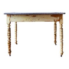 an old wooden table with two legs and a stone top on it's base