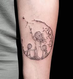 a woman's arm with a tattoo on it that has an image of two women in