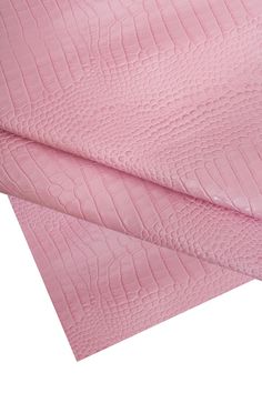 pink crocodile skin fabric on white background