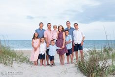 a family poses for a photo on the beach