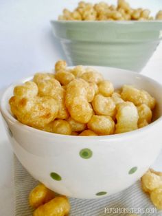 two bowls filled with food sitting on top of a white table next to each other