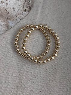 Gold filled beads are timeless and wearable for any occasion. - 14k gold filled beads- stretch finish- available in 6mm & 7mm- 1 bracelet per orderFor additional gold filled bracelet options click herehttps://www.etsy.com/listing/811298529/14k-gold-filled-bracelets-beaded?ref=shop_home_active_2 Classic Stretch Bracelet With Spacer Beads, Classic Stretch Bracelet With Polished Beads, Classic Gold Beads Stretch Bracelet Gift, Classic Gold Beads Stretch Bracelet As Gift, Classic Gold Beads Stretch Bracelet For Gift, Classic Stackable Stretch Bracelet With Round Beads, Classic Gold Stretch Bracelet With 8mm Beads, 14k Gold Filled 8mm Round Bead Bracelets, 14k Gold-filled Bracelets With 8mm Beads