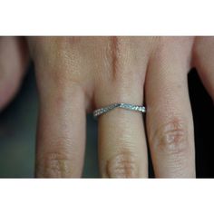 a woman's hand with a wedding band on it, and the ring is white gold