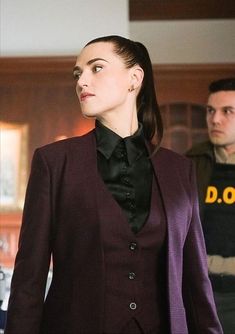 a woman in a purple suit and black shirt