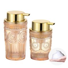 two glass jars with gold lids on each one and the other hand next to it