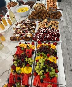 an assortment of fruits and pastries on a buffet table