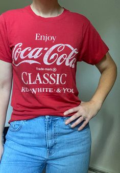 "This is an AMAZING true 1970's Coca Cola t-shirt! It's a 50/50 cotton poly blend and has been worn to perfect vintage t-shirt softness! It's super soft and slightly thin- not see through but a nice thin fabric. The Coca Cola on the front is in white, and there's nothing printed on the back! I've seen this t-shirt before but all have had something printed on the back (like another brand, company, etc). This is truly an amazing piece.  Attached tag, Screen Stars, 50/50 cotton poly blend. Made in White Screen, Red Tee, Red T Shirt, Red T, Red Tshirt, Fancy Dresses, 50 50, Vintage Tshirts, Coca Cola