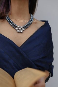 Get your hands on the floral Victorian Polki necklace with grey pearls to accentuate your feminine grace. Embedded with high-grade Polkis and zirconia, the pendant necklace is beautifully handcrafted by the artisans of India. Bejewel your neckline with our magnificent pearl necklace which is a replica of Bollywood jewelry and has the charm to spruce up your look. Necklace Closure - Adjustable Dori Style Tip - Created out of our fascination with radiance, bling, and luxury. These designs embody t Pearl Necklace With Saree, Elegant Gray Necklace For Wedding, Silver Pearl Pendant Necklace For Celebration, Festive Bollywood Necklace With Pearl Pendant, Bollywood Style Silver Pearl Necklace, Victorian Jewelry Indian Pendant, Victorian Jewelry Necklace, Luxury Victorian Pearl Necklace, Luxury Victorian Pearl Pendant Necklace