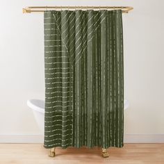 a green shower curtain with white lines on it and a wooden pole in the background