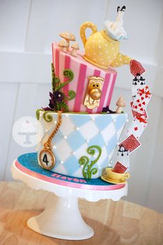 a multi - tiered cake decorated with colorful designs