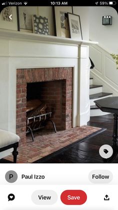 a fire place sitting in the middle of a living room next to a stair case