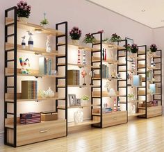 an empty room with shelves filled with books and vases