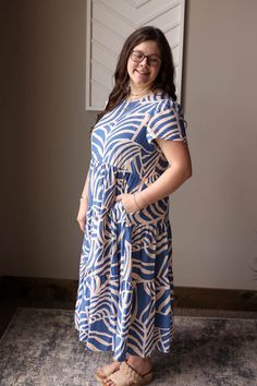 This Blue Boho Tiered Maxi Dress is perfect for a happy and simple summer look. The light weight material will keep you comfortable while the flowy tiered design adds a touch of feminine chic. Plus, it has pockets for added convenience! The Fit of This Boutique Maxi Dress: See HOW TO MEASURE Here. TOP: Flat Across Measurements in Inches Size: Chest Across Waist Across Length Small 17 25 45 Medium 18 26 45 Large 19 27 46 X-Large 21 29 47 2XL Casual Tiered Dress For Spring, Casual Spring Tiered Dress, Spring Tiered Skirt Dress With Pockets, Spring Tiered Dress With Pockets, Flowy Tiered Short Sleeve Dress For Vacation, Flowy Short Sleeve Tiered Dress For Vacation, Flowy Tiered Vacation Dress With Short Sleeves, Flowy Tiered Dress With Short Sleeves For Vacation, Flowy Dress With Pockets For Vacation