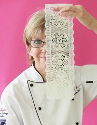 a woman holding up a piece of lace in front of her face