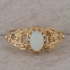 This ladies 14k yellow gold ring has one oval cabochon opal at the center that measures 7x5m in size. It is set into a prong/basket style setting with cut out filigree detailing along the sides of the ring. It weighs 3.3 grams and has a finger size of 7. *The opal is slightly abraided* Condition: Pre-Owned *All items are thoroughly inspected for quality assurance purposes Opal Wedding Ring, Basket Style, Opal Wedding, Yellow Gold Ring, Oval Cabochon, Quality Assurance, Yellow Gold Rings, Rings Statement, Unique Rings