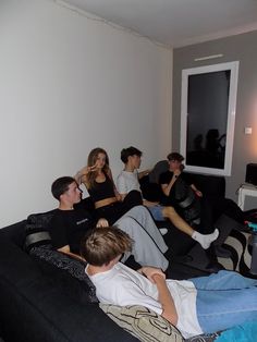 several people sitting on a couch in a living room