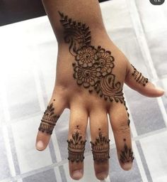 a person's hand with henna tattoos on it