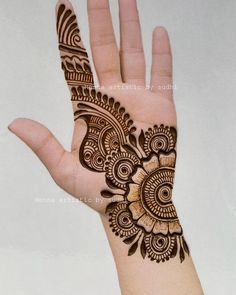 the hand is decorated with henna designs on it