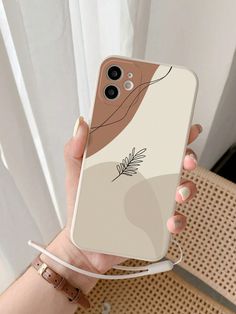 a woman holding up her phone case with an image of a plant on the back