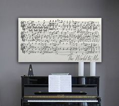 a piano sitting in front of a wall with musical notes on it's side