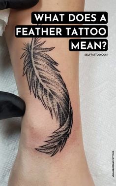 a black and white feather tattoo on the side of a woman's leg with text overlay that reads, what does a feather tattoo mean?