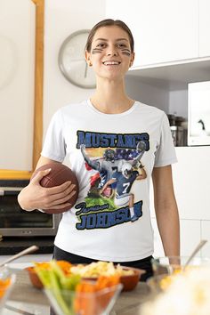 a woman holding a football in her hand and standing next to a bowl of salad