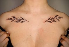 a woman's chest with two small leaves on her left shoulder and the upper part of her right arm