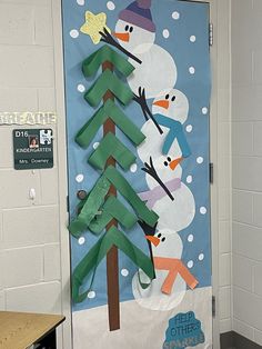 a classroom door decorated with snowmen and trees