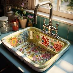 a kitchen sink with flowers painted on it