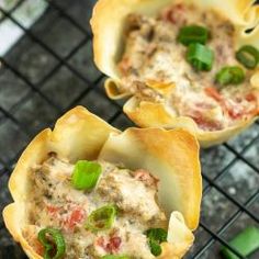 some food is sitting on top of a wire rack and ready to be cooked in the oven