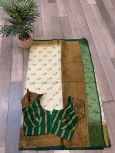 Ace your occasion wearing this beautiful contrast Banarasi kora organza handloom silk saree in light cream and green. Saree comes with green, fully stitched blouse and falls and pico done. Saree is beautifully bordered with antique zari. Blouse fits bust size upto 42 inches and can be altered to fit you. Chanderi Saree In Off White For Diwali, Diwali Off-white Chanderi Saree, Off White Chanderi Saree For Diwali, Cream Chanderi Saree For Diwali, White Tissue Silk Blouse With Zari Weaving, White Cotton Silk Traditional Wear With Border, Chanderi Saree With Zari Weaving In Off White, Diwali Off White Saree With Self Design, Off White Self Design Saree For Diwali