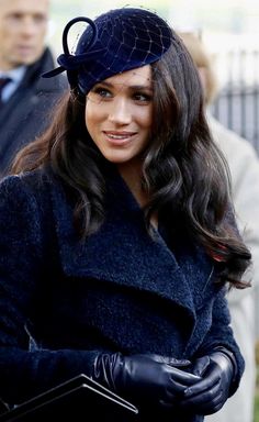 a woman in a blue coat and black gloves