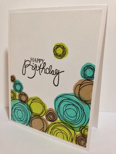 a birthday card with colorful circles and the words happy birthday written in cursive writing