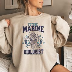 🎅Last day for Christmas orders Dec 8th🎄 🌊 Dive into the Depths of Style with our Future Marine Biologist Sweatshirt the perfect gift for any Biology Student. 🐋 ♡ PRODUCT: We use the finest premium Gildan 18000 crewneck sweatshirts, they are feather soft and very breathable with a good stretch. These garments are made from polyester and cotton. These sweatshirts are known for their great quality and much loved by our consumers. ♡ CARE INSTRUCTIONS: - Machine wash cold inside out on delicate c Marine Biology Clothes, Marine Biologist Outfit, Biology Shirt, Future Marine, Biology Student, Save The Ocean, Marine Biologist, Marine Biology, Book Shirts