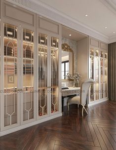 an elegant dining room with wood floors and white walls, along with glass doors that lead into the closet