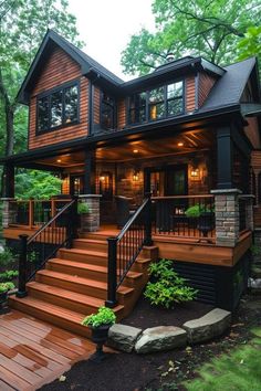 a large wooden house with stairs leading up to the front door and second story porch