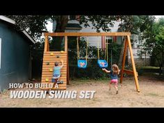 two children playing on a wooden swing set