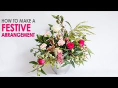 a vase filled with lots of flowers on top of a white table next to a sign that says how to make a festive arrangement