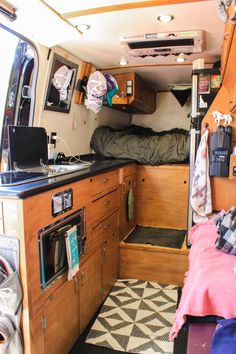 the interior of a camper van with bunk beds and kitchenette in place for sleeping