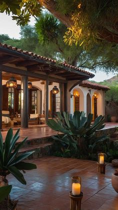 an outdoor patio with candles and potted plants