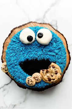 cookie monster cake with eyes and cookies on top