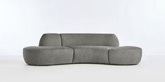 a gray couch sitting on top of a white floor