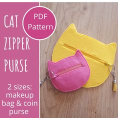 the zipper purse is made out of felt and has a cat design on it's side