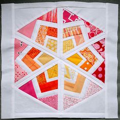 a close up of a patchwork quilt on a piece of cloth