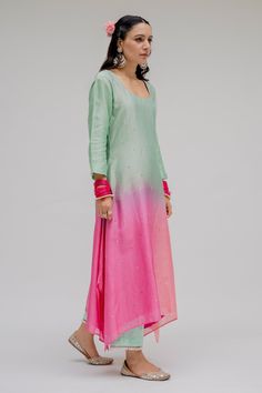 Mint ombre kurta in chanderi silk base with hand embroidered sequins detailing on the front,, asymmetric hemline and back potli button. Paired with cotton half elasticated pant with pearl embroidered detailing on the hem and dupatta with digitally printed motifs and gold fringe border.
Component: 3
Pattern: Embroidered
Type Of Work: Sequins
Neckline: Scoop
Sleeve Type: Straight
Fabric: Chanderi Silk; Cotton; Lining: Shantoon
Color: Blue, Pink
Other Details: 
A-line kurta
Mint to pink ombre
Asymm Slub Silk Straight Kurta With Mirror Work, Straight Slub Silk Kurta With Mirror Work, Summer Straight Kurta In Raw Silk, Summer Raw Silk Straight Kurta, Summer Anarkali Raw Silk Kurta, Summer Kurta In Raw Silk With Zari Work, Summer Chanderi Kurta With Dori Work, Summer Straight Kurta With Gota Work, Summer Traditional Wear Chanderi With Gota Work