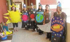 group of people in costumes holding up signs