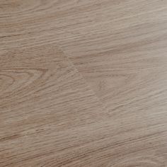 a close up view of a wood grain flooring surface with light brown stain on it