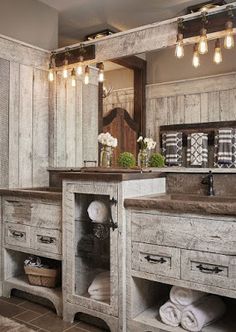 a rustic bathroom with two sinks and large mirror above the sink is decorated in whitewashed wood